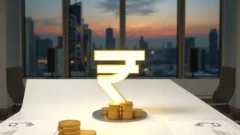 Large rupee symbol and coins on a boardroom table, representing the Jio IPO anchor round
