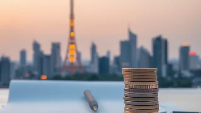 Telecom tower over a city skyline with rupee coins, representing the Jio Platforms IPO