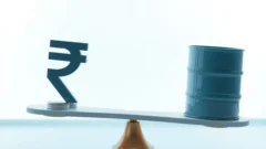 Rupee and dollar symbols balanced on a seesaw next to an oil barrel